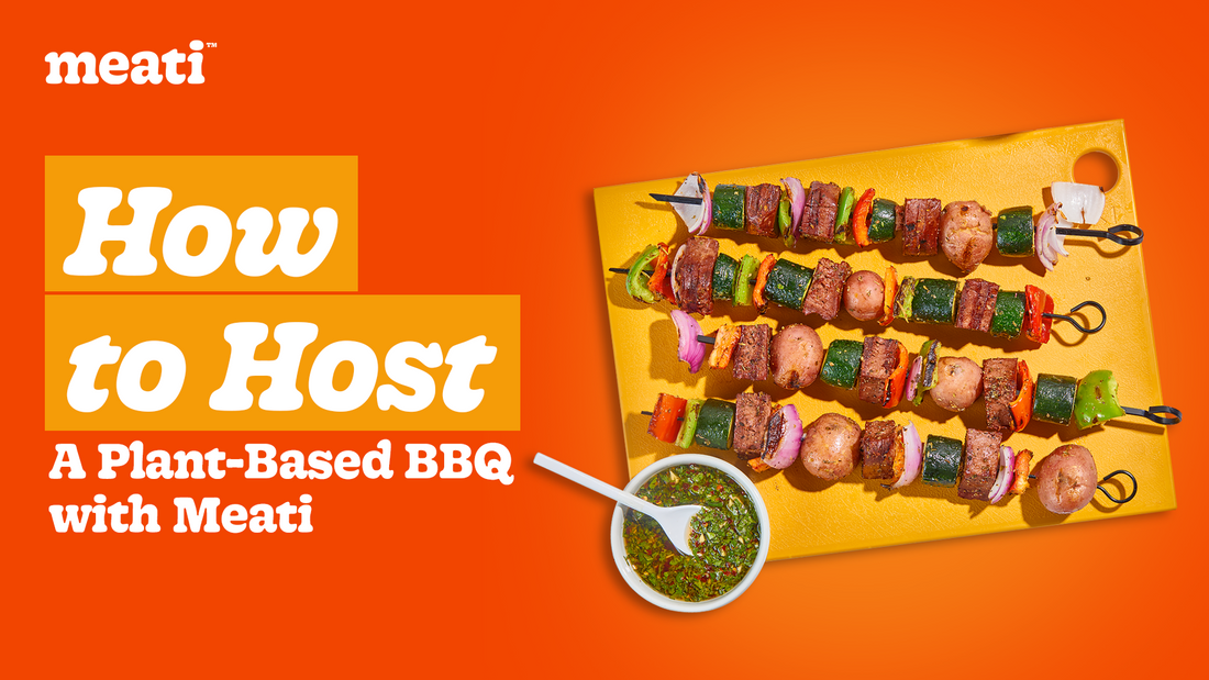 Meati plant-based kebabs with grilled vegetables and chimichurri sauce on a cutting board